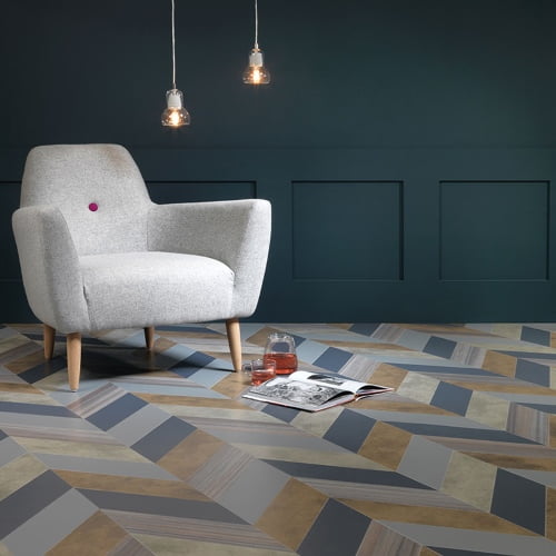 A lounge chair in a modern room with a vinyl floor.